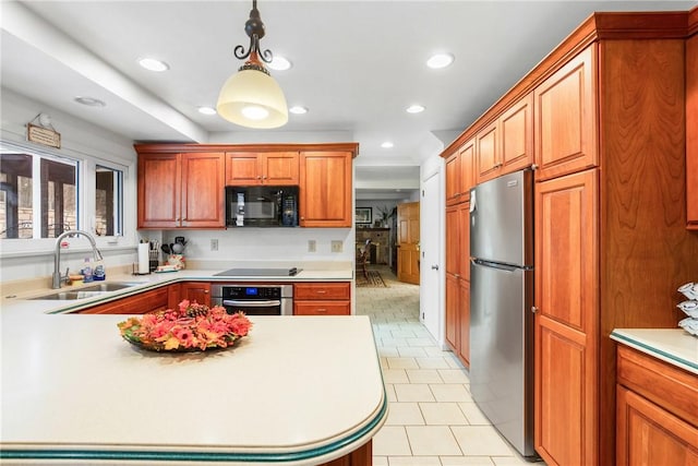 kitchen with sink, light tile patterned floors, pendant lighting, and appliances with stainless steel finishes