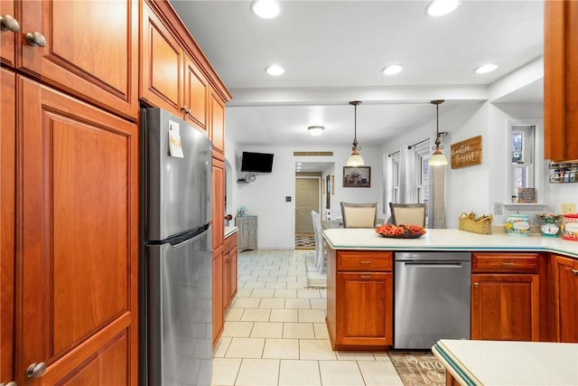 kitchen with kitchen peninsula, light tile patterned floors, stainless steel refrigerator, and hanging light fixtures