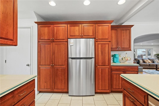 kitchen featuring stainless steel refrigerator and light tile patterned floors