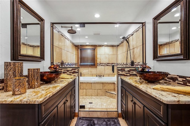 bathroom featuring shower with separate bathtub and vanity