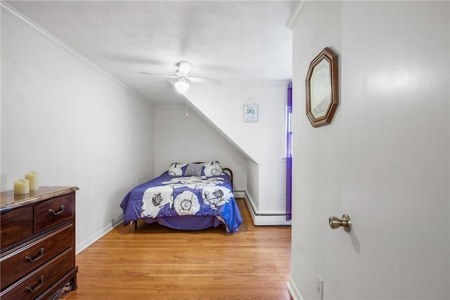 bedroom featuring ceiling fan, crown molding, and light hardwood / wood-style floors