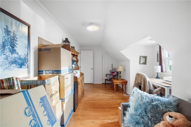 interior space with light hardwood / wood-style floors and vaulted ceiling