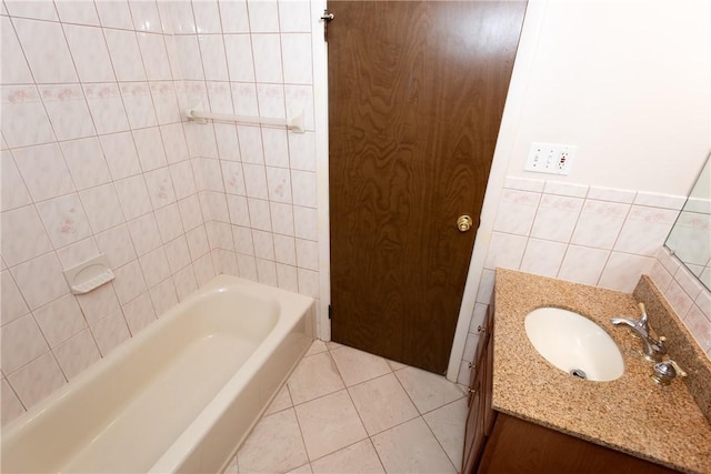 bathroom featuring tile patterned flooring, vanity, and tile walls