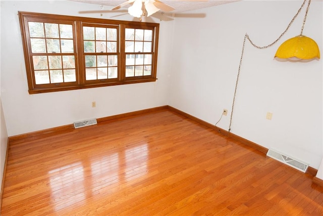 unfurnished room with ceiling fan and wood-type flooring