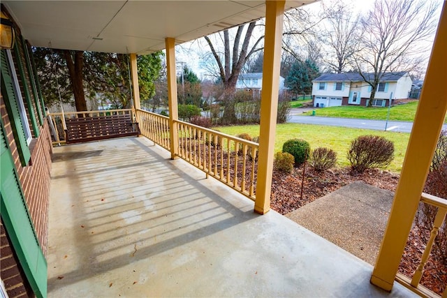 wooden deck with a yard and covered porch