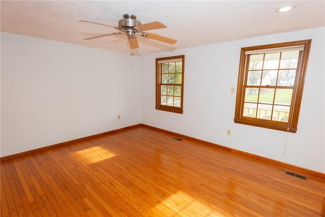 spare room featuring ceiling fan and light hardwood / wood-style floors