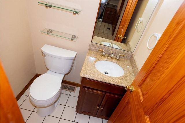 bathroom featuring tile patterned flooring, vanity, and toilet