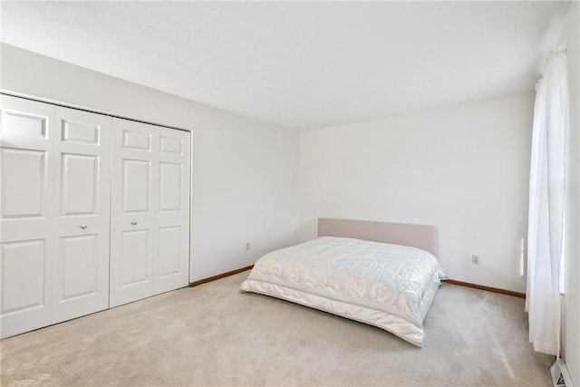 bedroom featuring light colored carpet and a closet