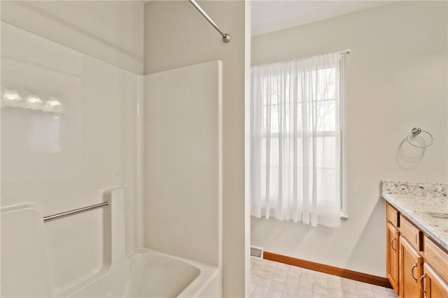 bathroom with vanity and  shower combination