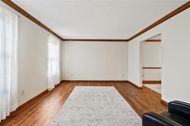 unfurnished living room with dark hardwood / wood-style floors and crown molding