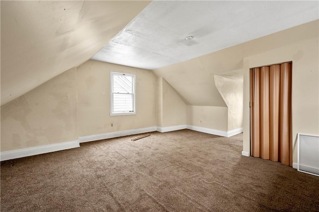 additional living space with carpet and vaulted ceiling