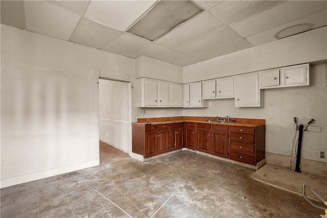 kitchen featuring sink and a drop ceiling