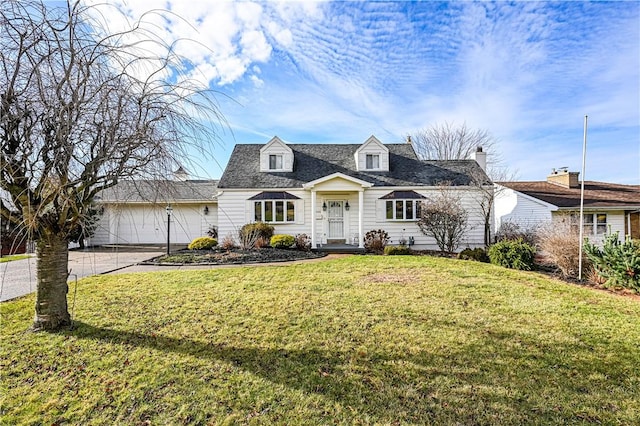 new england style home featuring a front yard and a garage