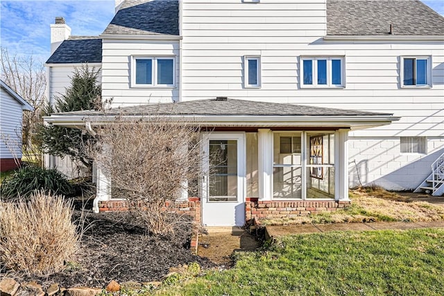 view of front of home with a front lawn and a sunroom