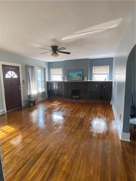 unfurnished living room featuring ceiling fan and hardwood / wood-style floors