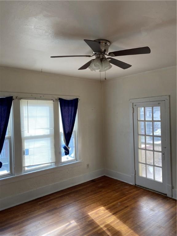 spare room featuring hardwood / wood-style floors and ceiling fan