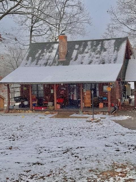 view of snow covered back of property