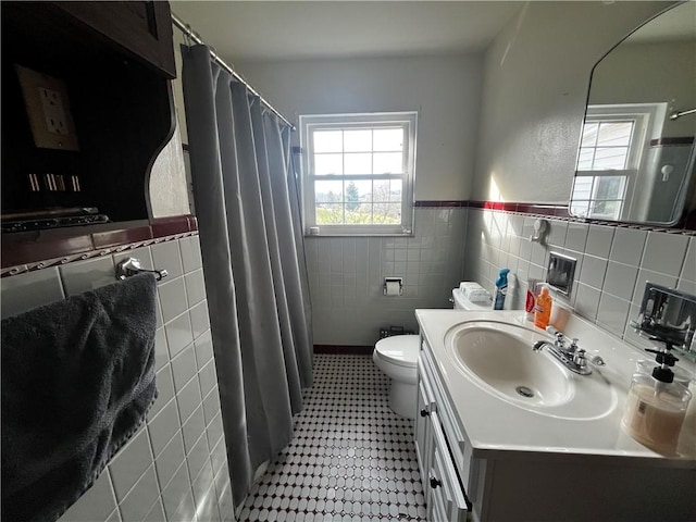 503 Melvin Dr, City Of Greensburg, PA 15601 - full bathroom with tile walls, toilet, vanity, tile patterned floors, and a wainscoted wall