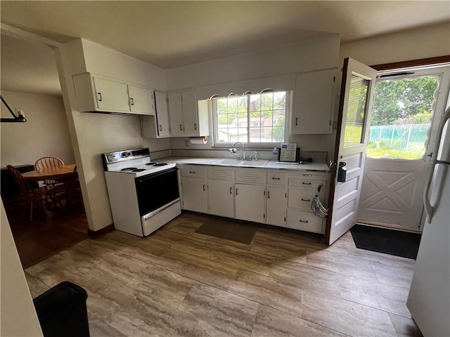 503 Melvin Dr, City Of Greensburg, PA 15601 - kitchen featuring white appliances, a sink, wood finished floors, light countertops, and white cabinets