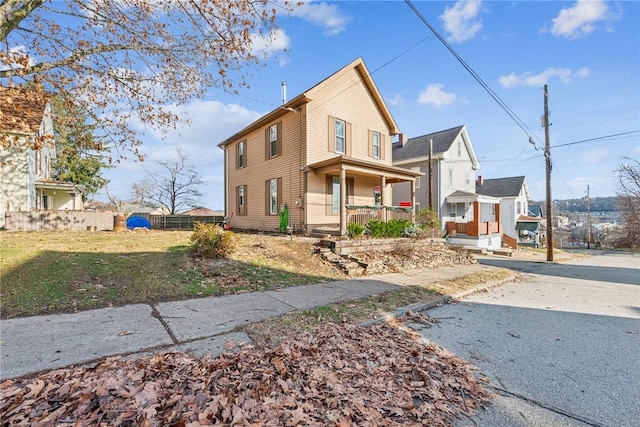 view of front of home featuring covered porch and a front yard