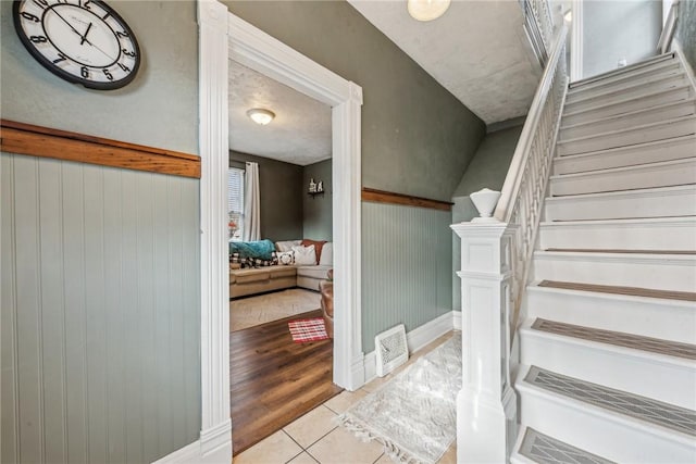 stairway featuring tile patterned floors