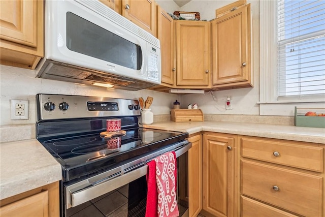 kitchen featuring electric stove and a healthy amount of sunlight