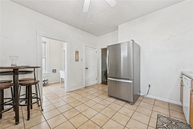 kitchen with stainless steel refrigerator, ceiling fan, and light tile patterned flooring