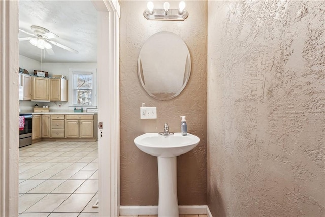 bathroom with ceiling fan, tile patterned flooring, and sink