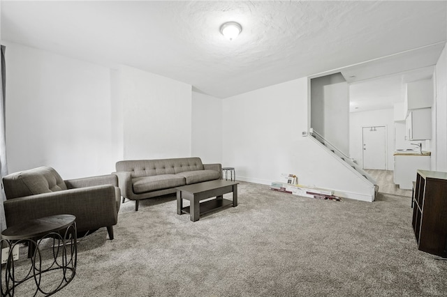 living room featuring light colored carpet and a textured ceiling