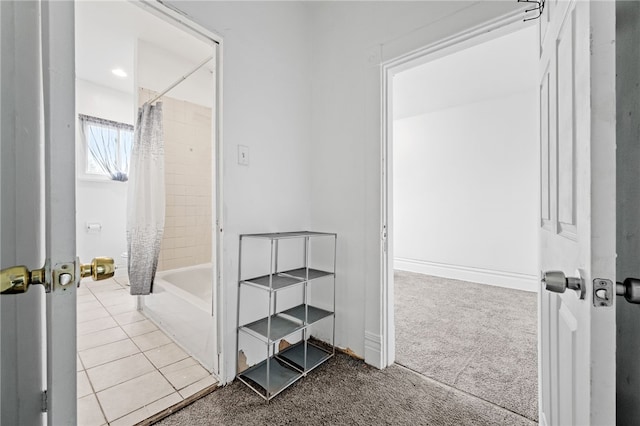 hallway featuring light colored carpet