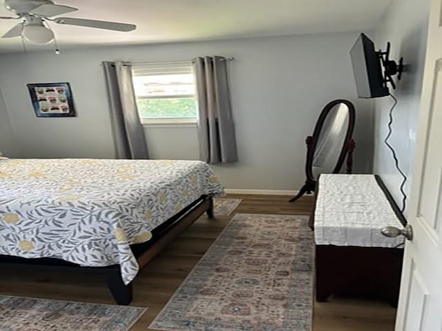 bedroom featuring ceiling fan and dark hardwood / wood-style floors