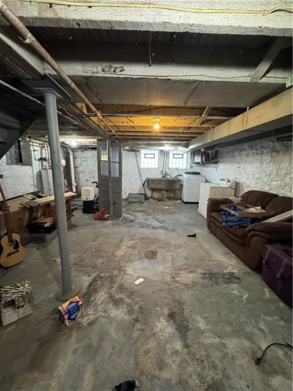 basement featuring washer / dryer and sink