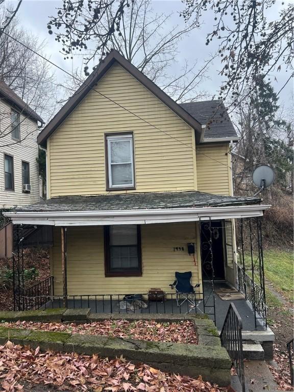 back of house featuring covered porch