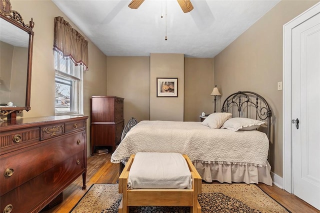 bedroom featuring hardwood / wood-style floors and ceiling fan