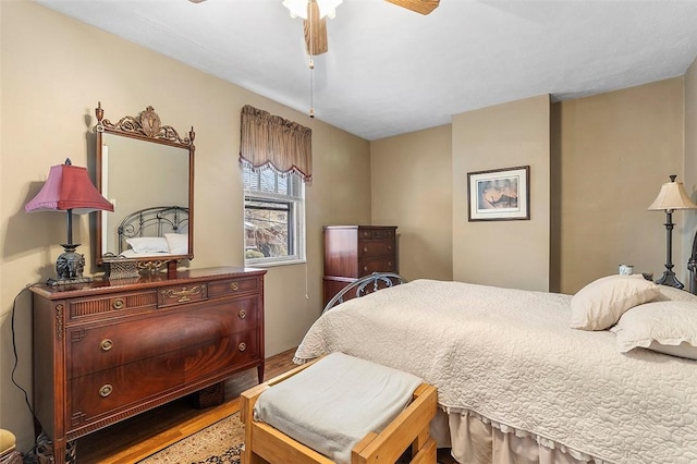 bedroom with ceiling fan and wood-type flooring