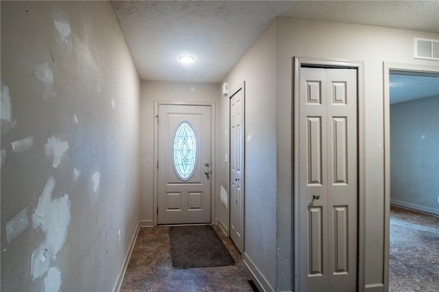 doorway featuring a textured ceiling