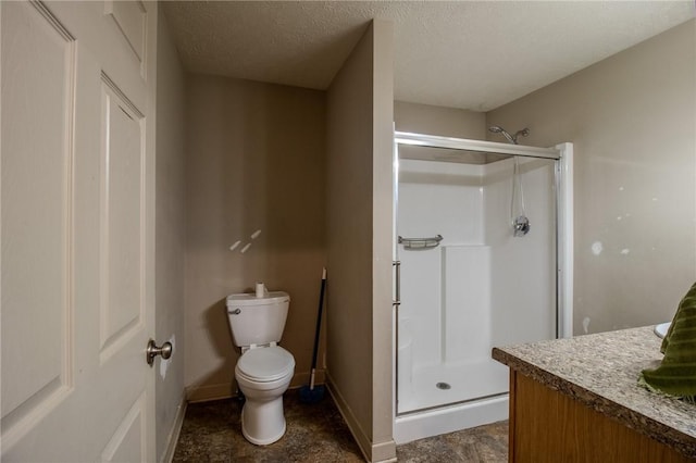 bathroom featuring a shower with door, vanity, a textured ceiling, and toilet