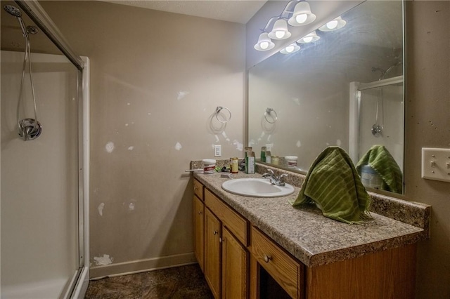 bathroom with vanity and a shower with door