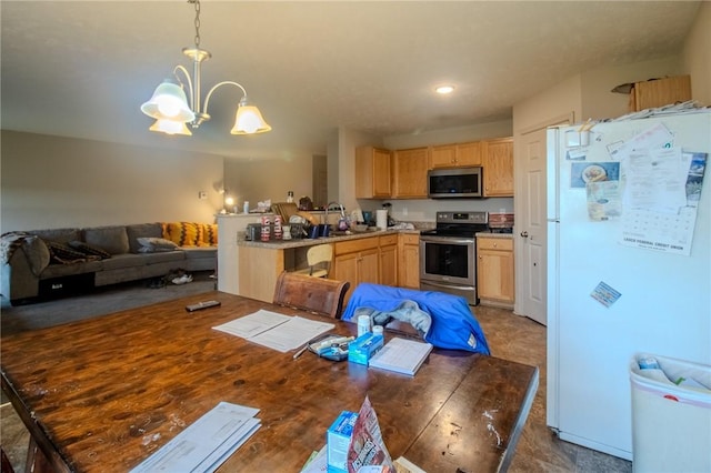 kitchen featuring light brown cabinetry, stainless steel appliances, decorative light fixtures, and an inviting chandelier