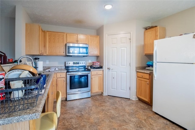 kitchen featuring appliances with stainless steel finishes and light brown cabinets