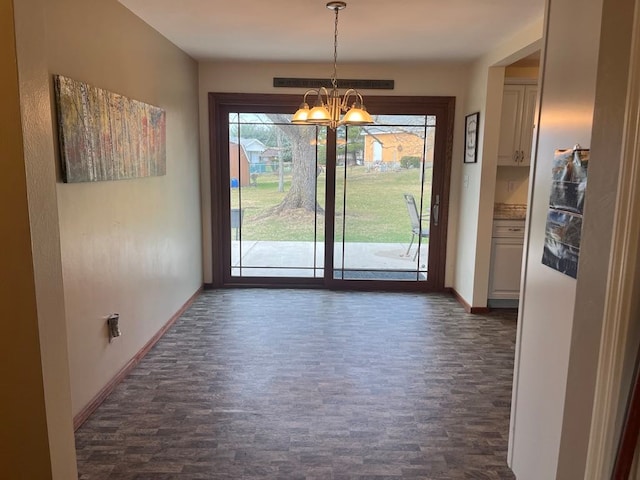 unfurnished dining area featuring a notable chandelier