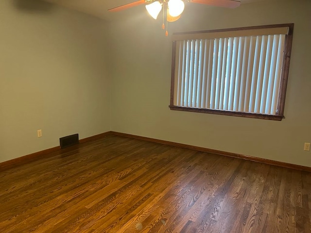 spare room with ceiling fan and dark hardwood / wood-style flooring