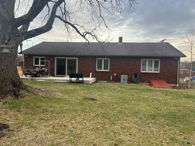 back of property with a patio area, a yard, and central AC unit