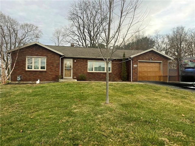 single story home featuring a garage and a front yard