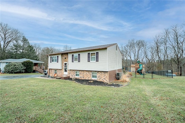 raised ranch with a playground and a front lawn