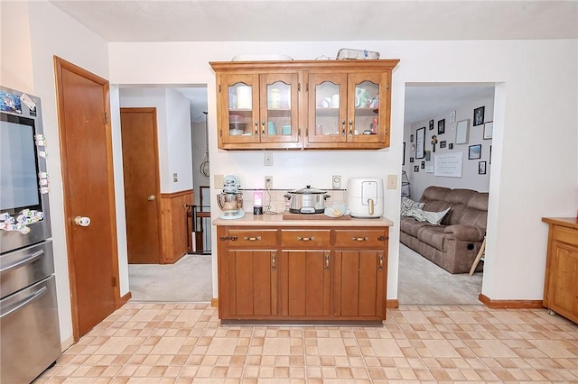 kitchen featuring stainless steel fridge and light carpet