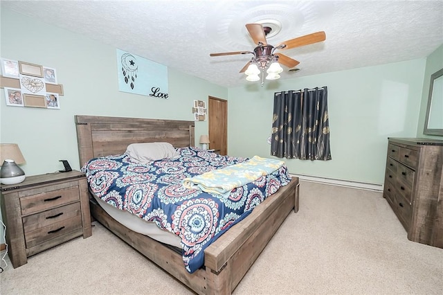 carpeted bedroom featuring ceiling fan, a textured ceiling, and a baseboard radiator