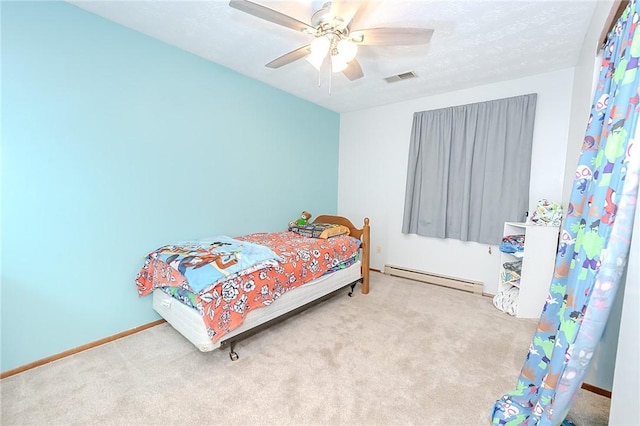 carpeted bedroom with baseboard heating and ceiling fan