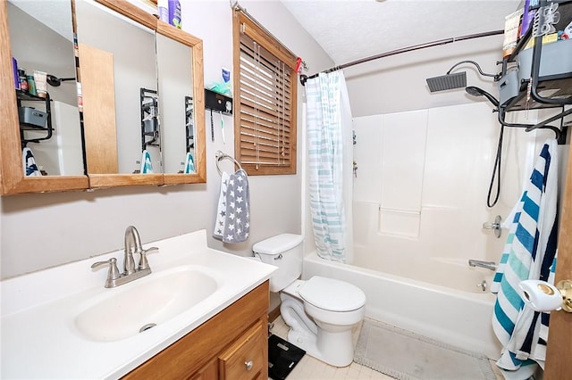 full bathroom with vanity, toilet, shower / bath combo with shower curtain, and a textured ceiling