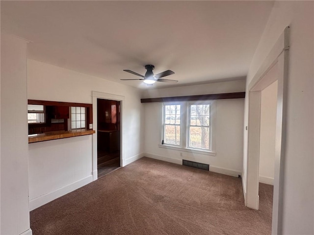 unfurnished living room featuring carpet floors and ceiling fan